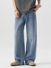 Men’s light-wash denim jeans with a wide leg relaxed fit and classic stitching details for casual wear