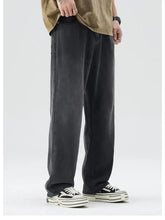 Men’s wide-leg relaxed fit jeans in black denim with a slightly faded wash and classic five-pocket design