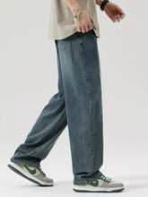Men’s dark-wash denim relaxed fit jeans with a wide leg and visible stitching details for casual wear