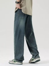 Men’s wide leg relaxed fit jeans in dark-wash denim with classic stitching details and a relaxed fit cut