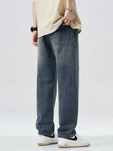 Men’s dark-wash denim relaxed fit jeans with a wide leg and classic back pockets shown from the back side