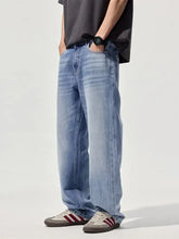 Men’s wide-leg relaxed fit jeans in light-wash denim with subtle fading for a casual modern look