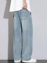 Men’s wide leg relaxed fit jeans in light-wash denim with visible stitching details and a relaxed wide-leg cut