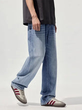 Men’s wide-leg relaxed fit jeans in light-wash blue denim with a straight-leg cut for casual wear