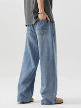 Men’s light-wash denim wide leg relaxed fit jeans with frayed hems and a relaxed fit design