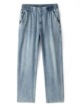 Men’s wide leg relaxed fit jeans in light wash denim with elastic waistband and side pockets for comfort