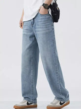 Men’s light-wash denim jeans with relaxed fit wide leg cut and subtle fading details for casual wear
