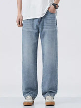 Men’s wide leg relaxed fit light-wash denim jeans with subtle fading for a casual modern look