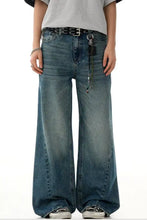 Men’s wide-leg denim jeans in medium blue vintage wash with subtle distressing and classic five-pocket design