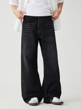Mens black wide leg wash jeans with faded distressed denim and subtle horizontal stitching details