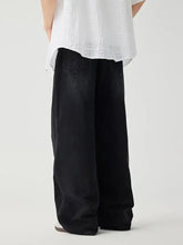 Men’s black wide leg wash jeans with a relaxed straight-cut silhouette and subtle fading details in denim material