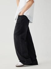 Men’s black wide leg wash jeans featuring a relaxed oversized fit in wide leg denim material