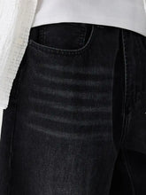 Men’s black denim wide leg wash jeans with faded texture and detailed visible stitching on front side
