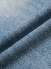 Blue denim fabric with a textured woven pattern for men’s wide leg wash jeans in a classic leg wash style