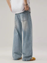 Men’s wide leg wash denim jeans in light wash with wide leg cut and subtle fading for casual wear