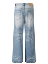 Men’s light-wash denim wide leg jeans with subtle fading featuring a comfortable wide leg wash design