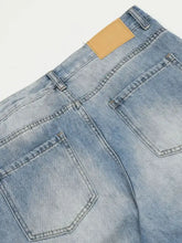 Men’s wide leg wash jeans in light-wash denim with a faded distressed look and contrasting dark stitching