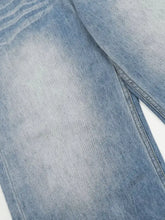 Men’s light-wash denim wide leg jeans with faded distressed texture and visible stitching along the seam