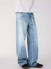 Men’s wide leg wash jeans in light-wash denim with subtle fading and wide leg cut for a modern casual look