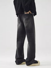 Black wide leg washed jeans in denim with a slightly faded and distressed finish for men
