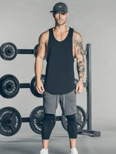 Man in mens wide strap tank, slightly stretchy athletic top