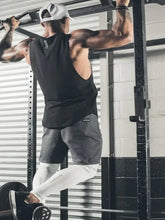 Man doing pull-up in slightly stretchy mens wide strap tank, grey shorts, white sleeves