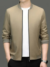 Beige men’s zip up long sleeve bomber jacket with black zipper and trim featuring a sleek modern design
