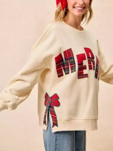 Cream-colored merry bow slit crew neck christmas sweatshirt with plaid lettering and slightly stretchy material machine wash cold