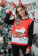 Woman in Merry Christmas long sleeve sweatshirt with reindeer antlers