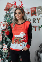 Woman in Merry Christmas long sleeve sweatshirt holding Santa mug