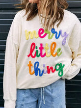 Cream-colored corduroy sweatshirt with colorful embroidered merry little thing lettering machine wash cold recommended