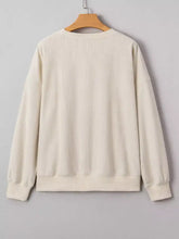 Cream-colored ribbed knit merry little thing sweatshirt with relaxed fit long sleeves machine wash cold instructions