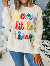 Cream-colored ribbed knit Merry Little Thing sweatshirt with rainbow-trimmed lettering machine wash cold recommended