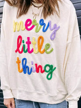 Cream-colored corduroy sweatshirt with colorful hand-embroidered merry little thing lettering, machine wash cold recommended