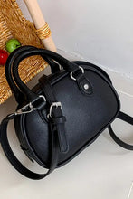 Black leather handbag with silver hardware and crossbody strap