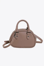 Taupe dome-shaped leather handbag with crossbody strap and silver hardware