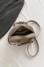 Taupe leather handbag with silver hardware and adjustable strap