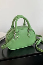 Mint green leather handbag with silver hardware and adjustable strap
