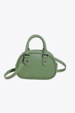Sage green leather handbag with bow detail and adjustable strap