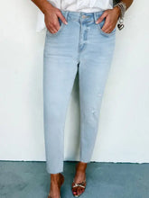 Mid rise ankle-length distressed skinny jeans in light-wash denim with slight stretch and frayed hem detailing