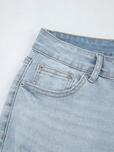 Mid rise ankle-length distressed skinny jeans in light-wash denim with slight stretch and silver-toned rivets