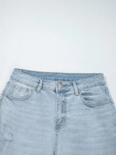 Mid rise ankle-length light-wash distressed skinny jeans with a slight stretch and a distressed patch on the left thigh