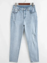 Mid rise ankle-length light-wash denim distressed skinny jeans with ripped details and slight stretch for comfort