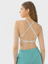 White scoop neck active cami with crisscross back, removable pads and lace trim