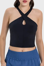Black halter neck crop top with crisscross straps, bust cutout detail