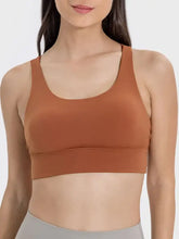 Terracotta racerback sports bra with crisscross scoop neck seamless fabric