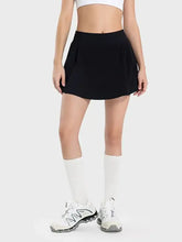 Black Millennia pleated active skirt with white trim, mid-rise waist, hip pockets