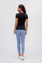 Millennia round neck short sleeve active t-shirt with blue leggings and white sneakers