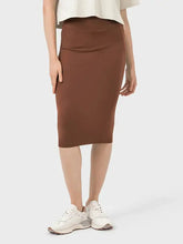Brown Millennia slit wrap active skirt with elastic waistband and white sneakers