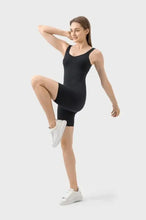 Millennia Wide Strap Active Romper in black leotard with white sneakers and socks